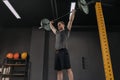 Sportsman holding barbell overhead at dark gym Royalty Free Stock Photo