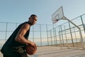 Sportsman holding basketball ball on sports court Royalty Free Stock Photo