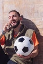 Sportsman laughing and talking by phone