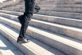 Sportsman legs climbing staircase at his training