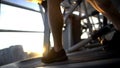 Sportsman legs walking on treadmill, sunset training after work, stress relief