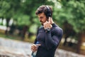 Sportsman listening to music while doing exercising in the park. Fitness, sport, lifestyle concep Royalty Free Stock Photo