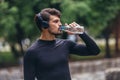 Sportsman listening to music while doing exercising in the park. Fitness, sport, lifestyle concep Royalty Free Stock Photo