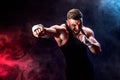 Sportsman muay thai boxer fighting on black background with smoke. Royalty Free Stock Photo