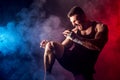 Sportsman muay thai boxer fighting on black background with smoke. Royalty Free Stock Photo