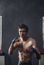 Sportsman muay thai boxer fighting in boxing hall Royalty Free Stock Photo