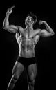 Sportsman. muscular sportsman with six pack, black and white. sportsman bodybuilder point on his muscle. biceps and