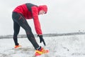 Sportsman during outdoor winter training session at snowy field background