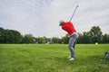 Sportsman practicing swings on the driving range Royalty Free Stock Photo