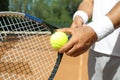 Sportsman preparing to serve tennis ball at court