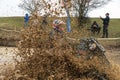 Sportsman on quad bike drives splashing in dirt and water at Mud Racing contest. ATV SSV