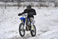 Sportsman racer man fulfills a fast ride on a motorcycle on the road extreme. The race track is very uneven. Royalty Free Stock Photo