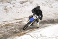 Sportsman racer man fulfills a fast ride on a motorcycle on the road extreme. The race track is very uneven.