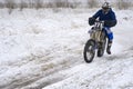 Sportsman racer man fulfills a fast ride on a motorcycle on the road extreme. The race track is very uneven.