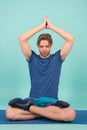 Sportsman relax in lotus pose. Man meditate on yoga mat. Fashion athlete practice yoga in gym. Meditation for body and mind health Royalty Free Stock Photo