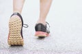 Sportsman runner feet running on road. close up on shoe behind of a man running fitness