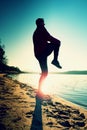 Sportsman running at amazing summer sunset along coastline in sport and healthy life style Royalty Free Stock Photo