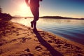 Sportsman running at amazing summer sunset at the beach in sport and healthy lifestyle concept Royalty Free Stock Photo