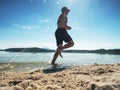 Sportsman running in water of lake in summer resort Royalty Free Stock Photo