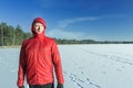 Sportsman at snowy winter outdoor landscape background in protective nylon jacket