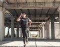 A sportsman on the sprint training at the unfinished,rustic ambient.