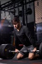 sportsman standing on his knee preparing to make deadlift at gym Royalty Free Stock Photo
