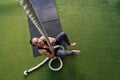 Sportsman strength training by climbing a rope