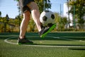 Sportsman tapping on his ankle while training at city football court