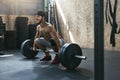 Sportsman Training With Barbell Row At Crossfit Gym