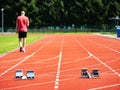 Sportsman walk on the running tracks after training. course.