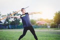 Man warming up and practicing javelin throw in yard