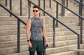 sportsman wearing sunglasses and wearable device technology watch while exercising. Muscular athlete exercising outside