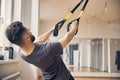 Sportsman working out using a suspension trainer Royalty Free Stock Photo