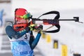 Sportswoman biathlete aiming, rifle shooting standing position. Biathlete Polina Yegorova Kazakhstan in shooting range