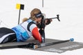 Sportswoman biathlete Elizaveta Eremeeva rifle shooting in prone position. Biathlete in shooting range of Open regional