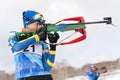 Sportswoman biathlete Kryukova Arina Kazakhstan rifle shooting in standing position. Biathlete in shooting range. Open