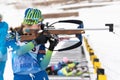 Sportswoman biathlete Legostaeva Anastasia rifle shooting in standing position. Biathlete in shooting range. Open