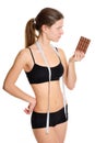 Sportswoman with chocolate. The problem and the temptation while