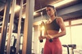 Sportswoman doing exercise for triceps in gym