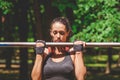 Sportswoman doing pullups in park. Royalty Free Stock Photo