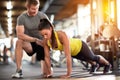 Sportswoman doing pushups with assisting