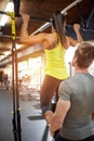 Sportswoman exercising with trainer in gym Royalty Free Stock Photo