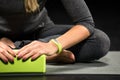 Sportswoman exercising with yoga block