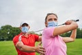 Sportswoman with a golf club over her head looking away Royalty Free Stock Photo