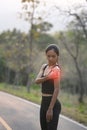 Sportswoman having pain and putting her hand on injury shoulder during jogging.