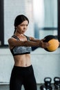 Sportswoman holding ball while working out in gym Royalty Free Stock Photo