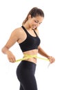 Sportswoman measuring her waist with a measure tape Royalty Free Stock Photo