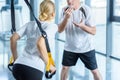 Sportswoman and senior trainer training with resistance band Royalty Free Stock Photo