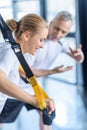 Sportswoman and senior trainer training with resistance band Royalty Free Stock Photo