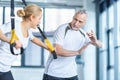 Sportswoman and senior trainer training with resistance band Royalty Free Stock Photo